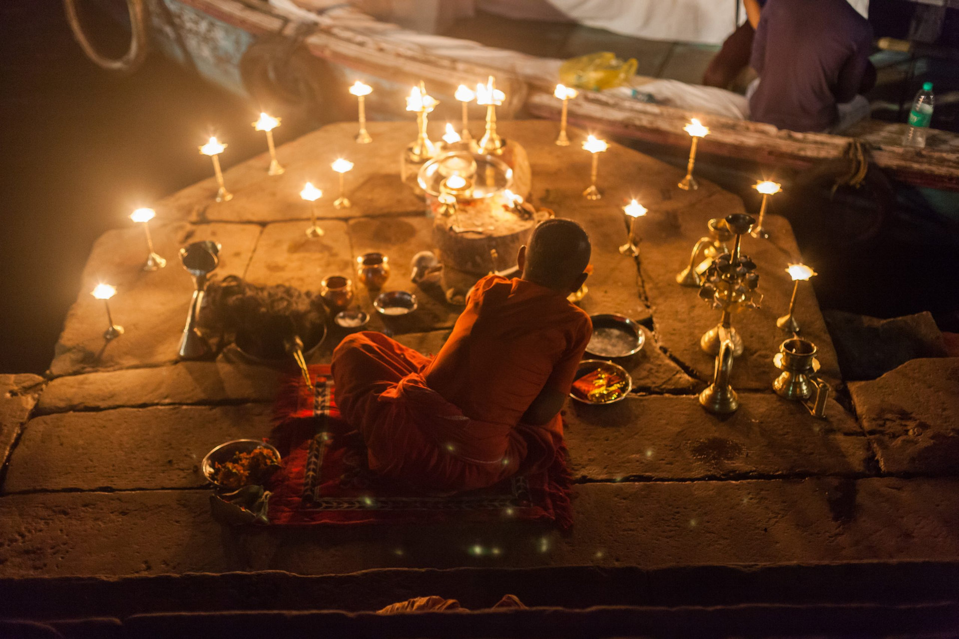 VARANASI, INDIA - 24 Oct 2016: A boy performs a religious ceremony to the Ganges on October 24, 2016 in Varanasi, India