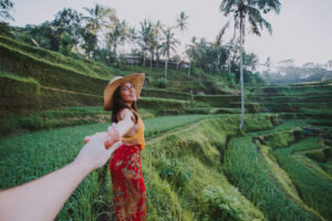 Beautiful girl visiting the Bali rice fields in tegalalang, ubud. Concept about people, wanderlust traveling and tourism lifestyle