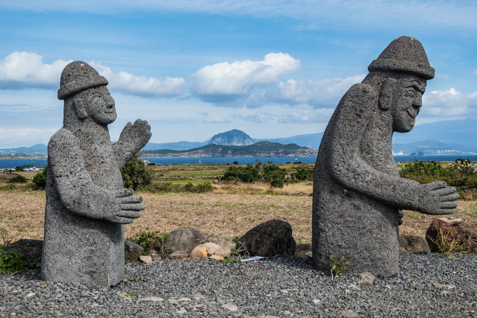 Dol hareubang (grandfather stone) volcanic rock statues along the Jeju Olle Trail, Gapado, Jeju, South Korea
