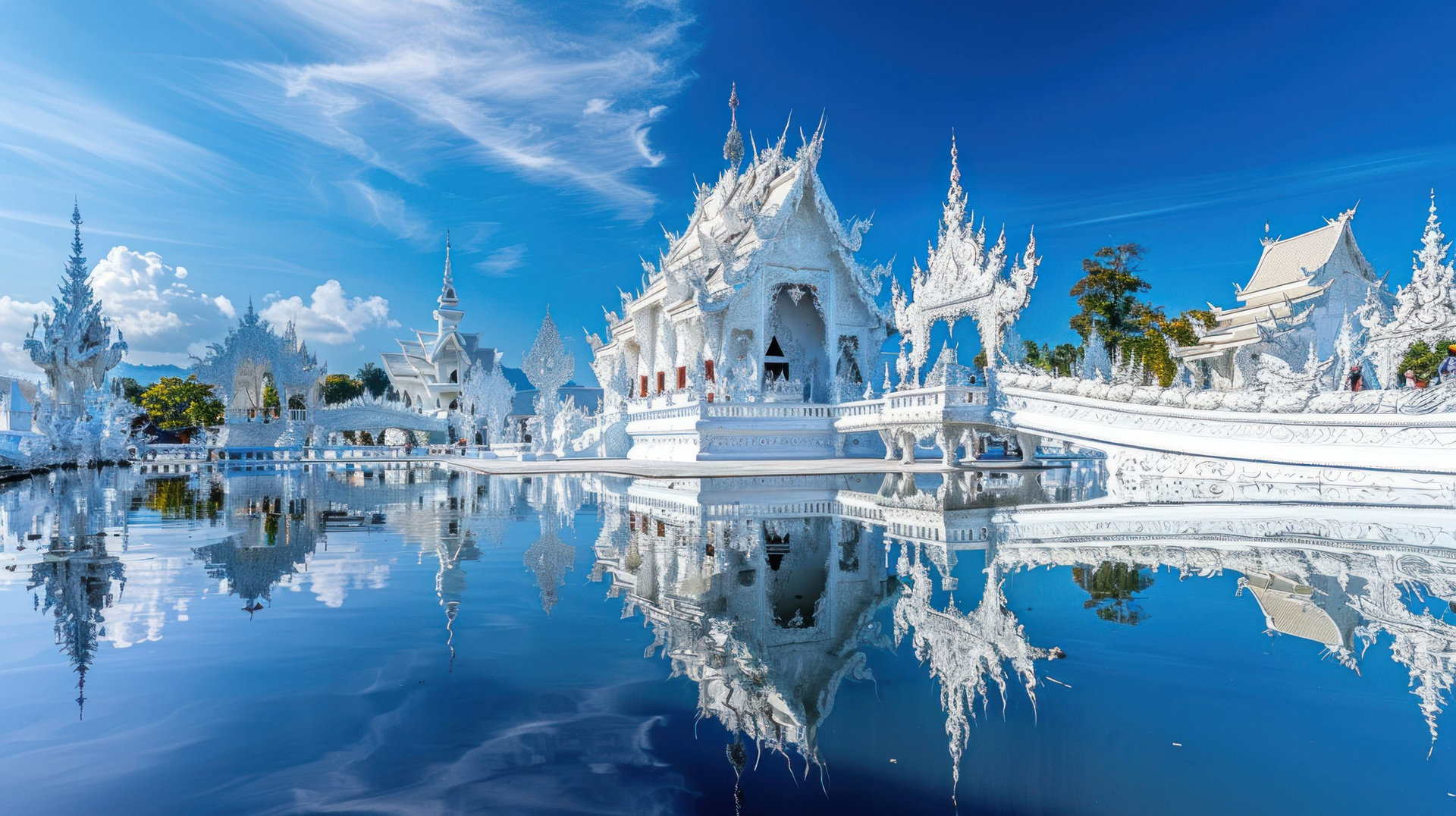 panoramic view of the white temple in Chiangorna, Thailand with reflection on the water surface and blue sky background. The White Temple is the most famous landmark building with a Rong architecture style, made from white concrete and decorated in the style of traditional Thai art design. In front of it there's a beautiful pond that reflects its shape and structure. --ar 16:9 Job ID: 7fb11939-8c97-4189-99ca-91eb9a70e18a