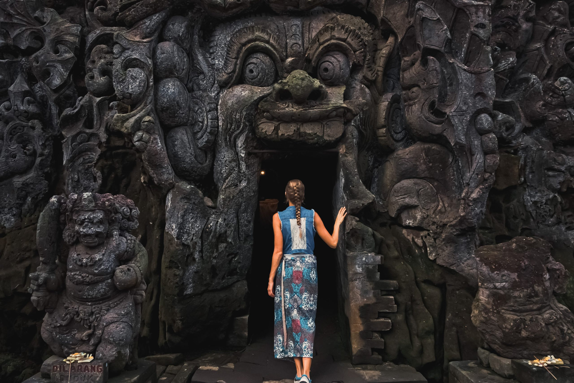 Female Tourist Entering Goa Gajah Elephant Cave in Bali, Indonesia.