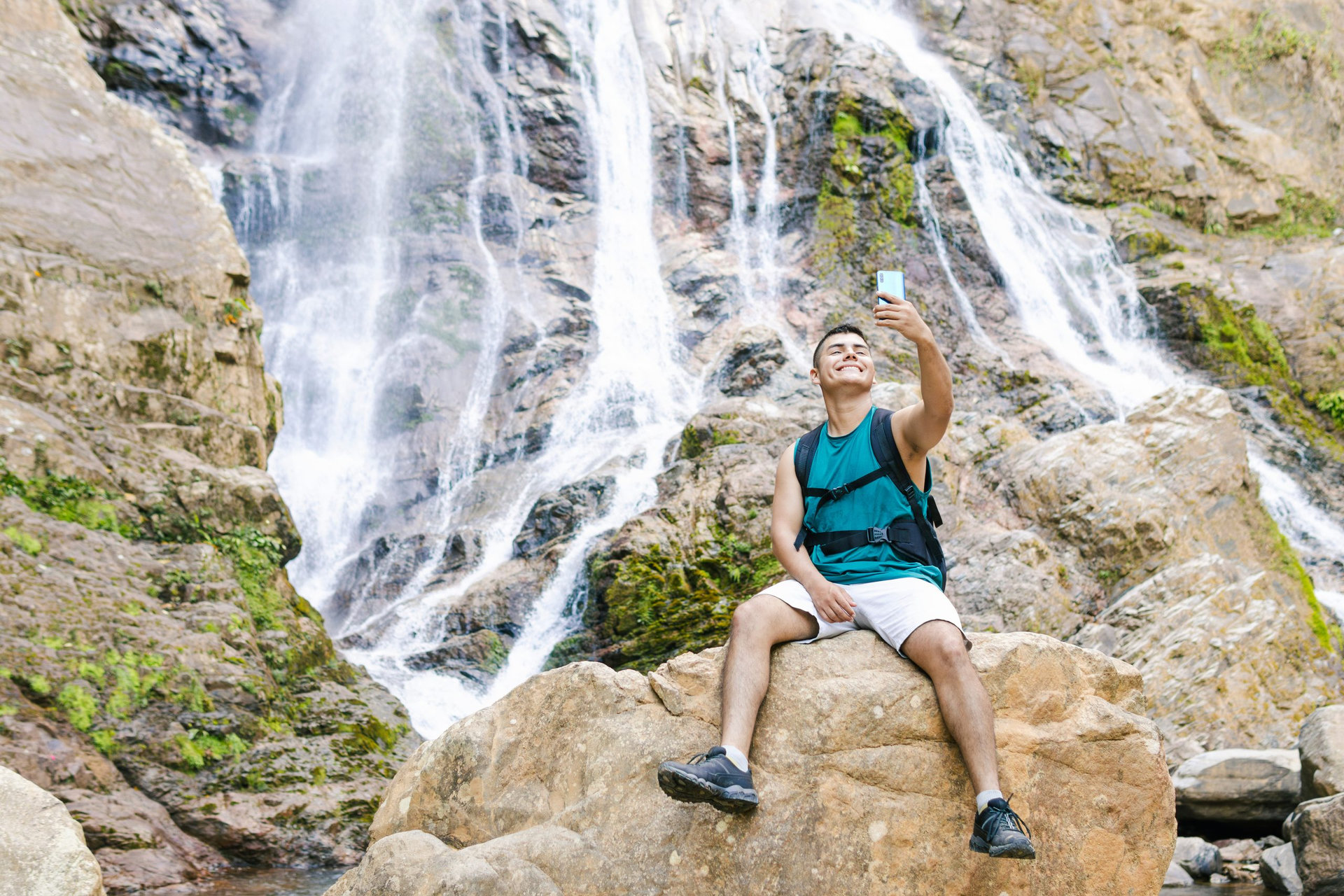 Backpacker enjoying a selfie by a colombian waterfall