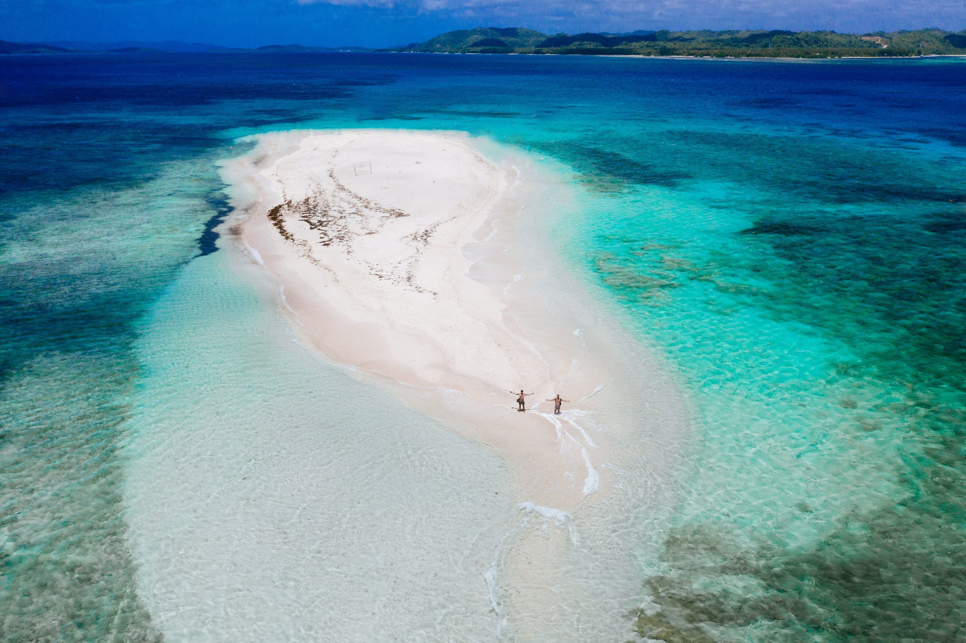 Naked island view from the sky. Man relaxing taking sunbath on the beach.shot taken with drone above the beautiful scene. concept about travel, nature, and marine landscapes