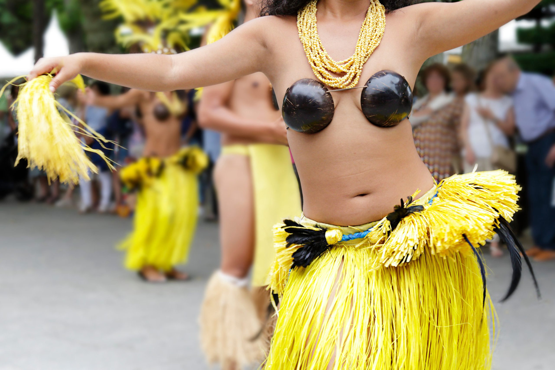 Dancers dancing and wearing the traditional folk costume from Tahiti, French Polynesia