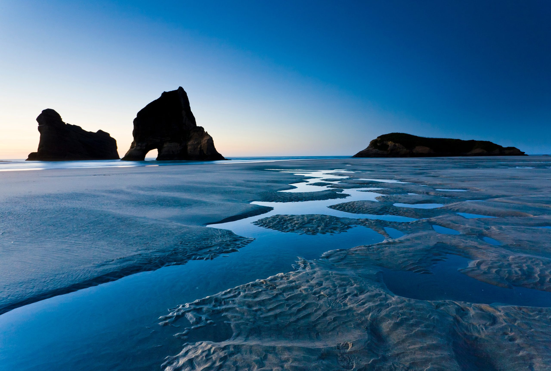 Rippled Sand and rock formations at Wharariki Beach, Nelson, North Island, New Zealand