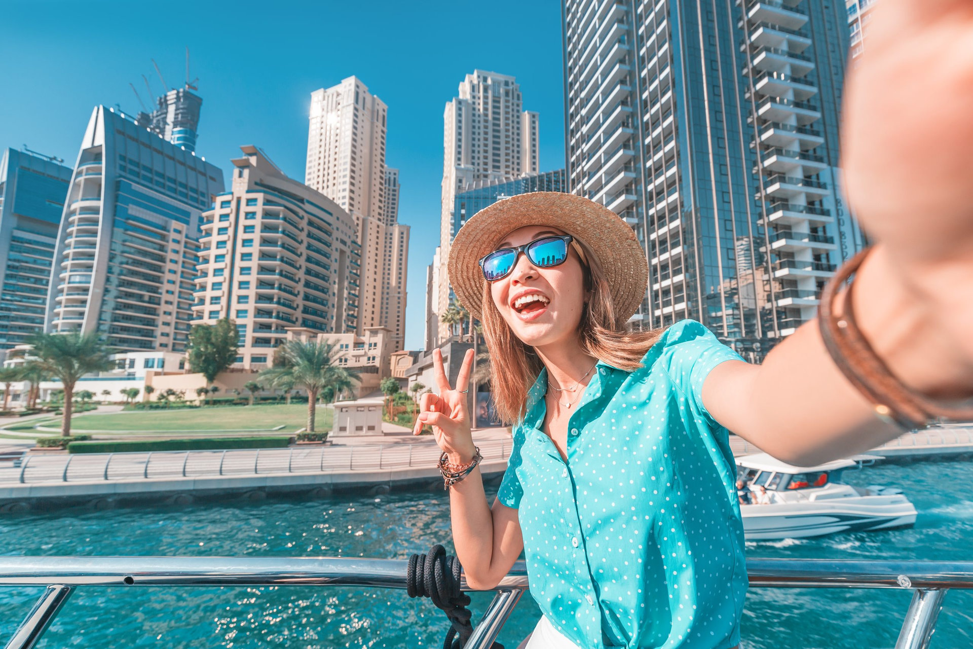Happy girl traveler taking selfie photo for her social networks in modern Finance center and bay area. Student and Tourist Blogger lifestyle concept