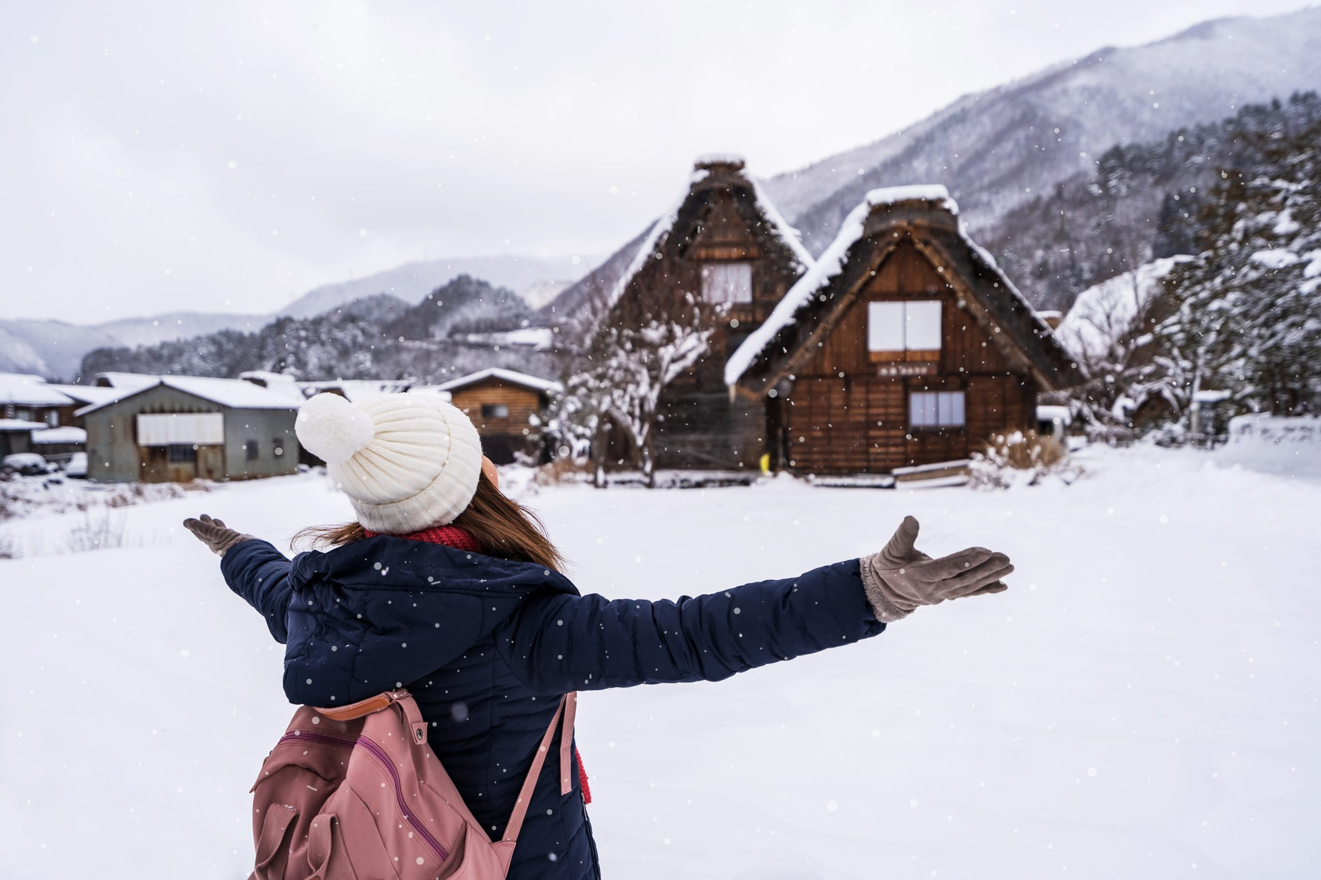 Young woman traveler enjoying with snow at shirakawa-go in winter