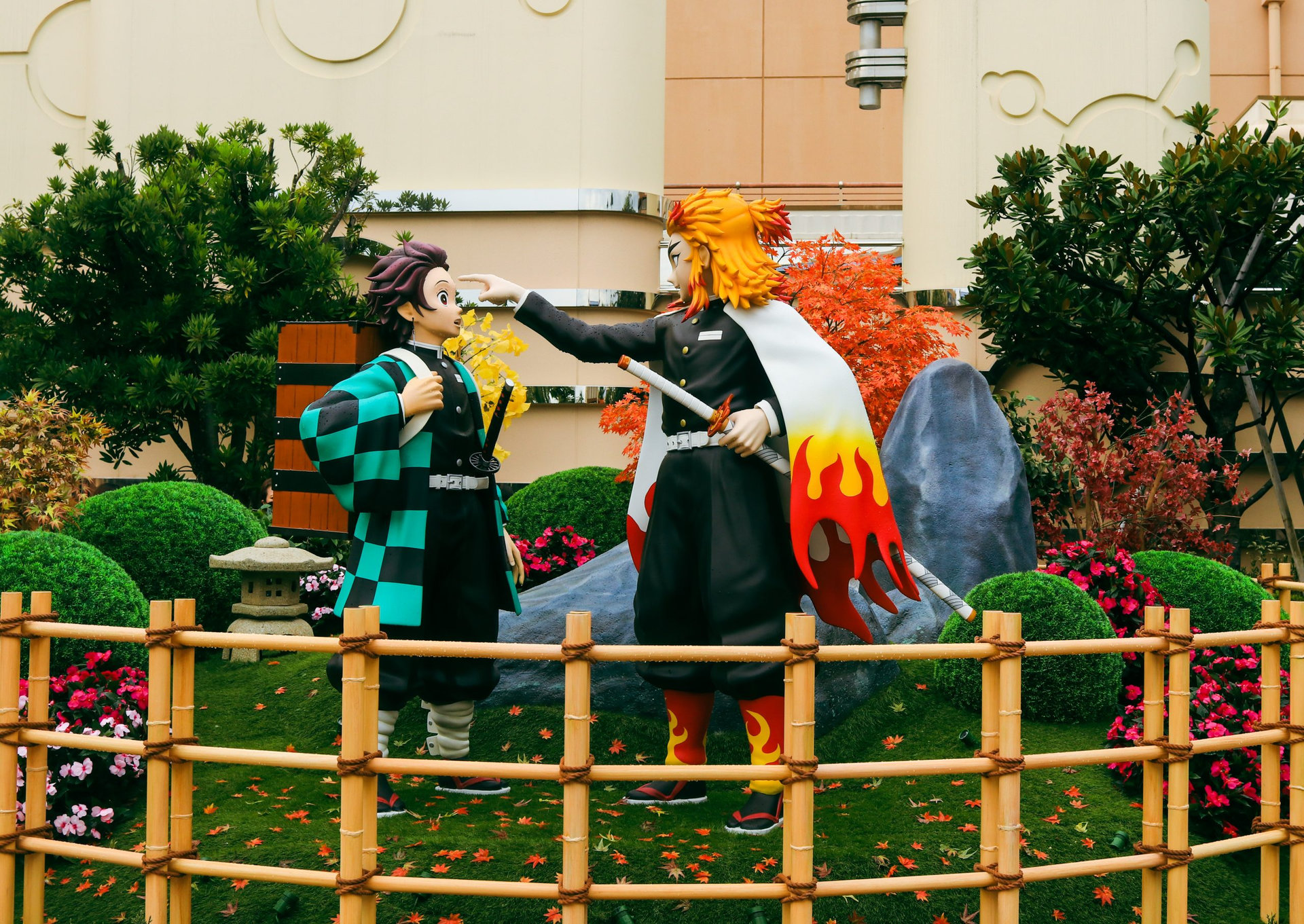 Osaka, Japan - September 17, 2021 - Statue of characters `Tanjiro Kamado` and `Kyojuro Rengoku` from the Anime `Demon Slayer` in the Universal Studios in Osaka in front of the Demon Slayer ride
