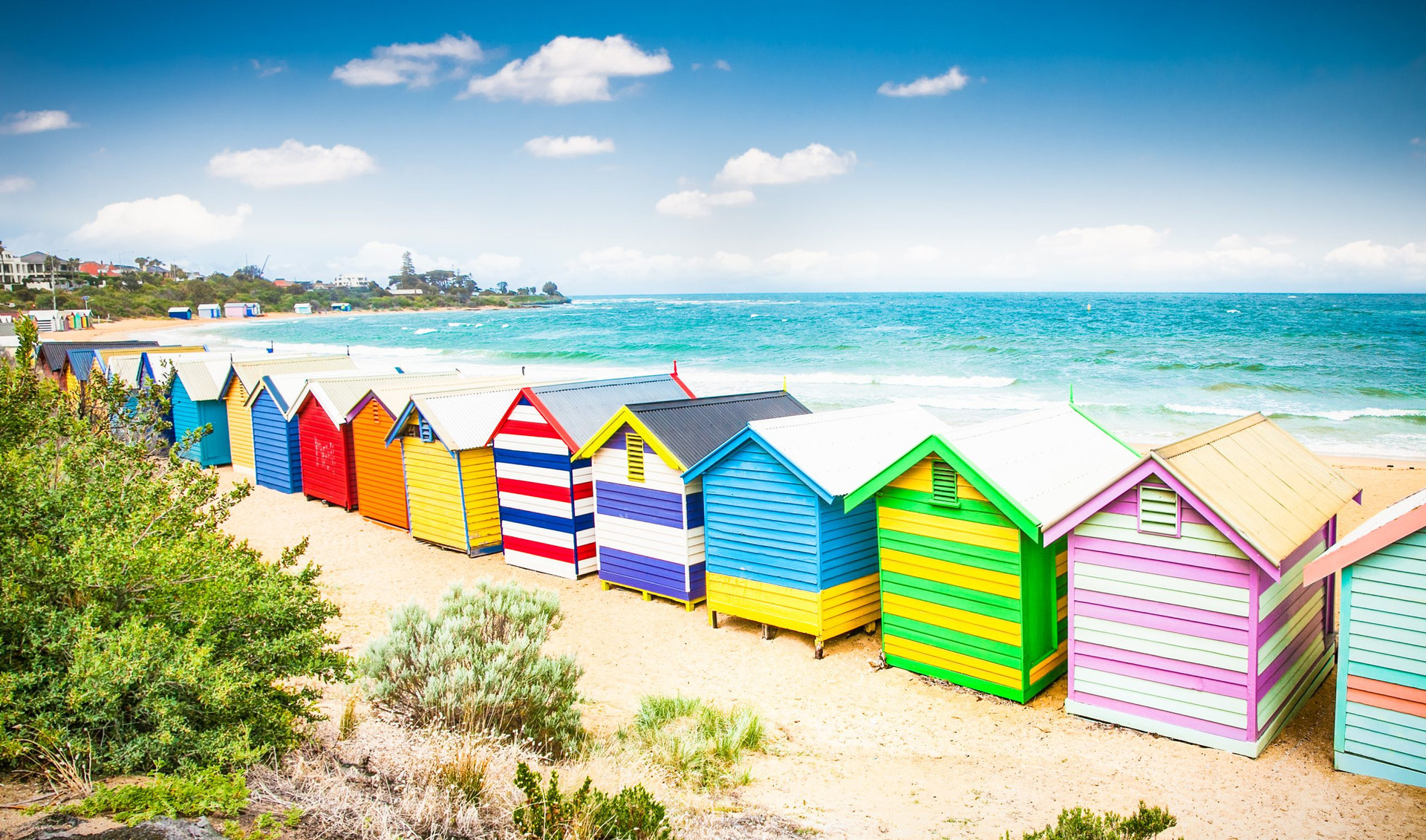Beautiful Bathing houses on white sandy beach at Brighton beach in Melbourne, Australia.