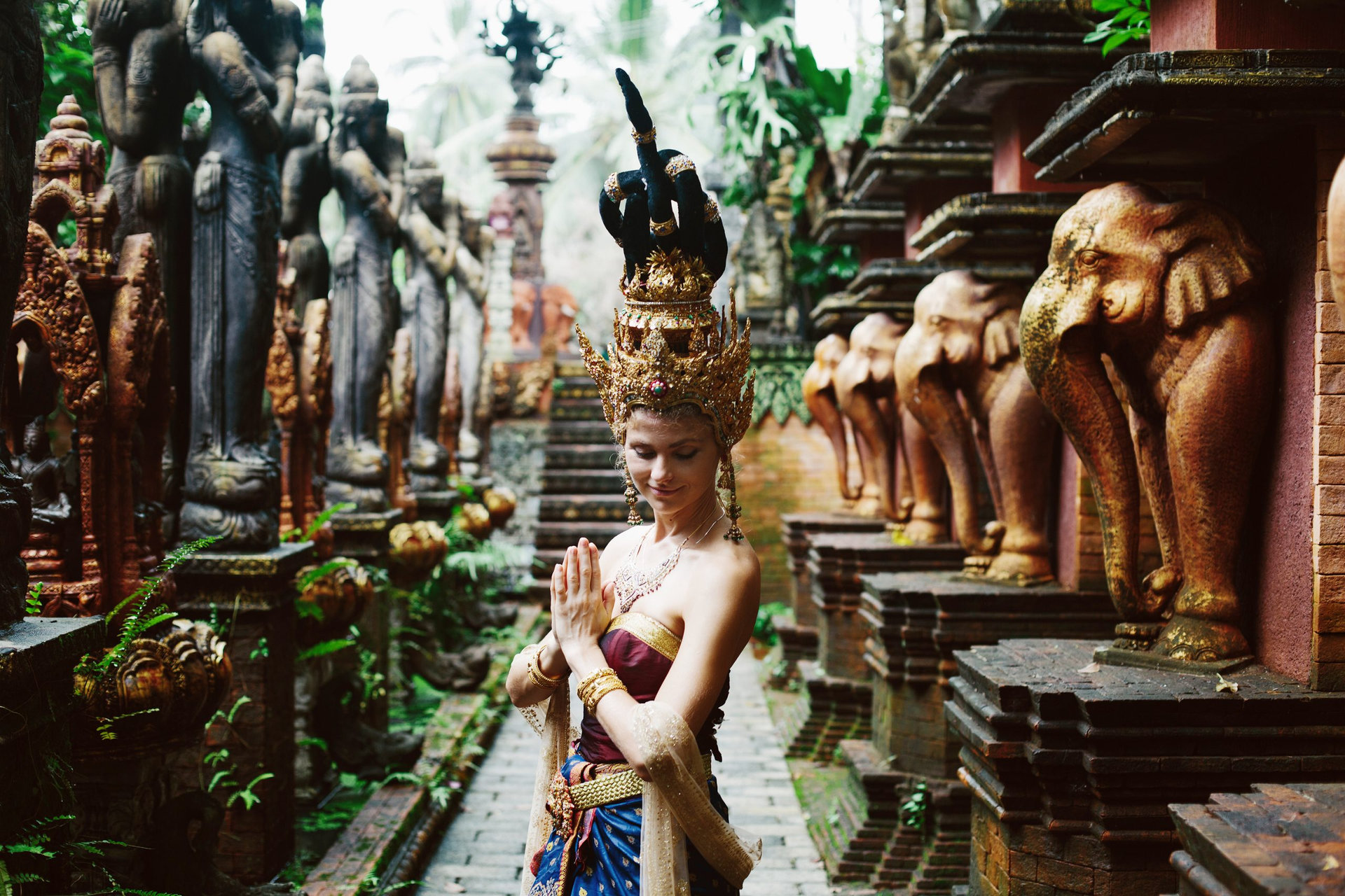Beautiful white woman in thai traditional costume. Asian queen portrait outdoor