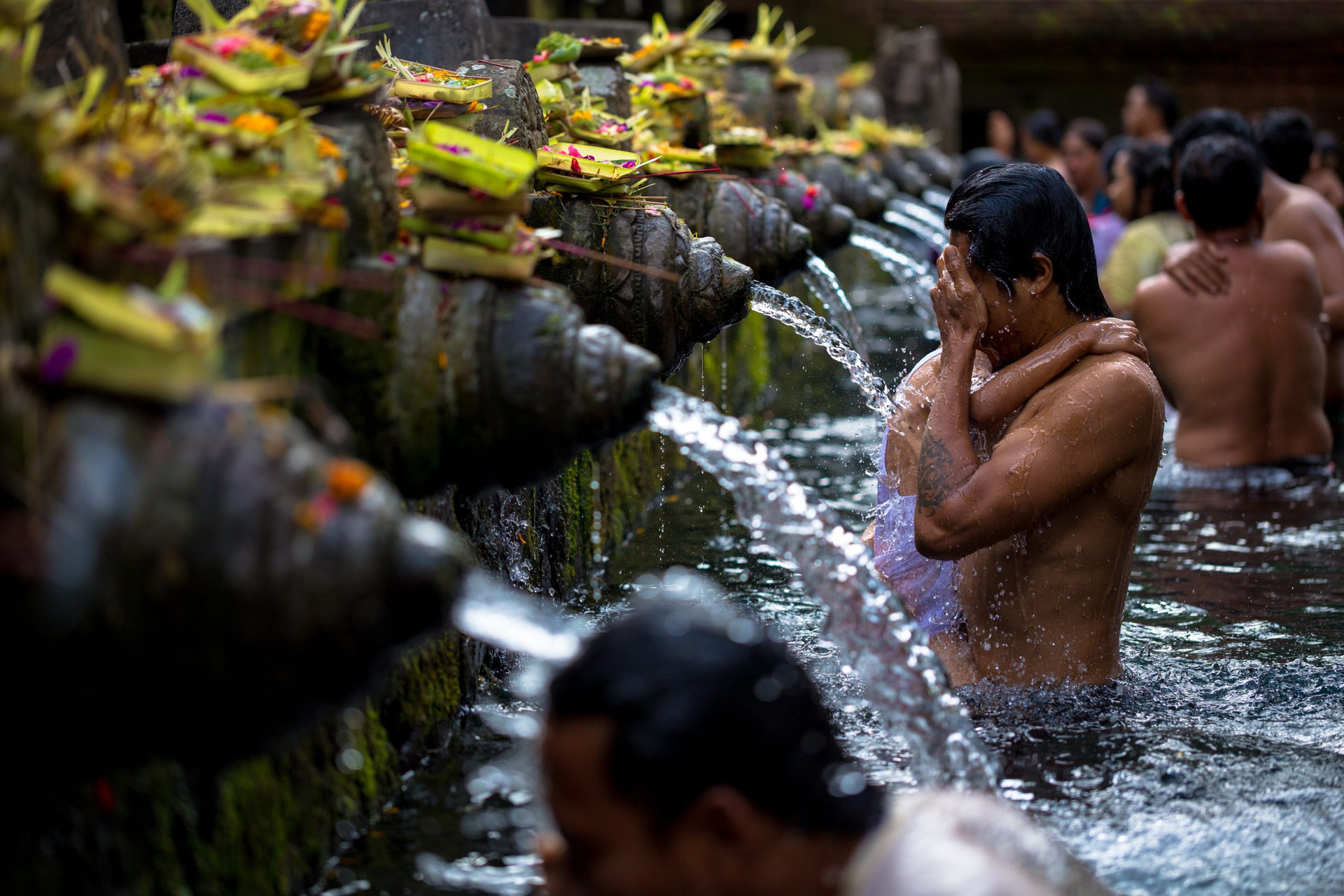 Man washes his face at Tirtha Empul water temple