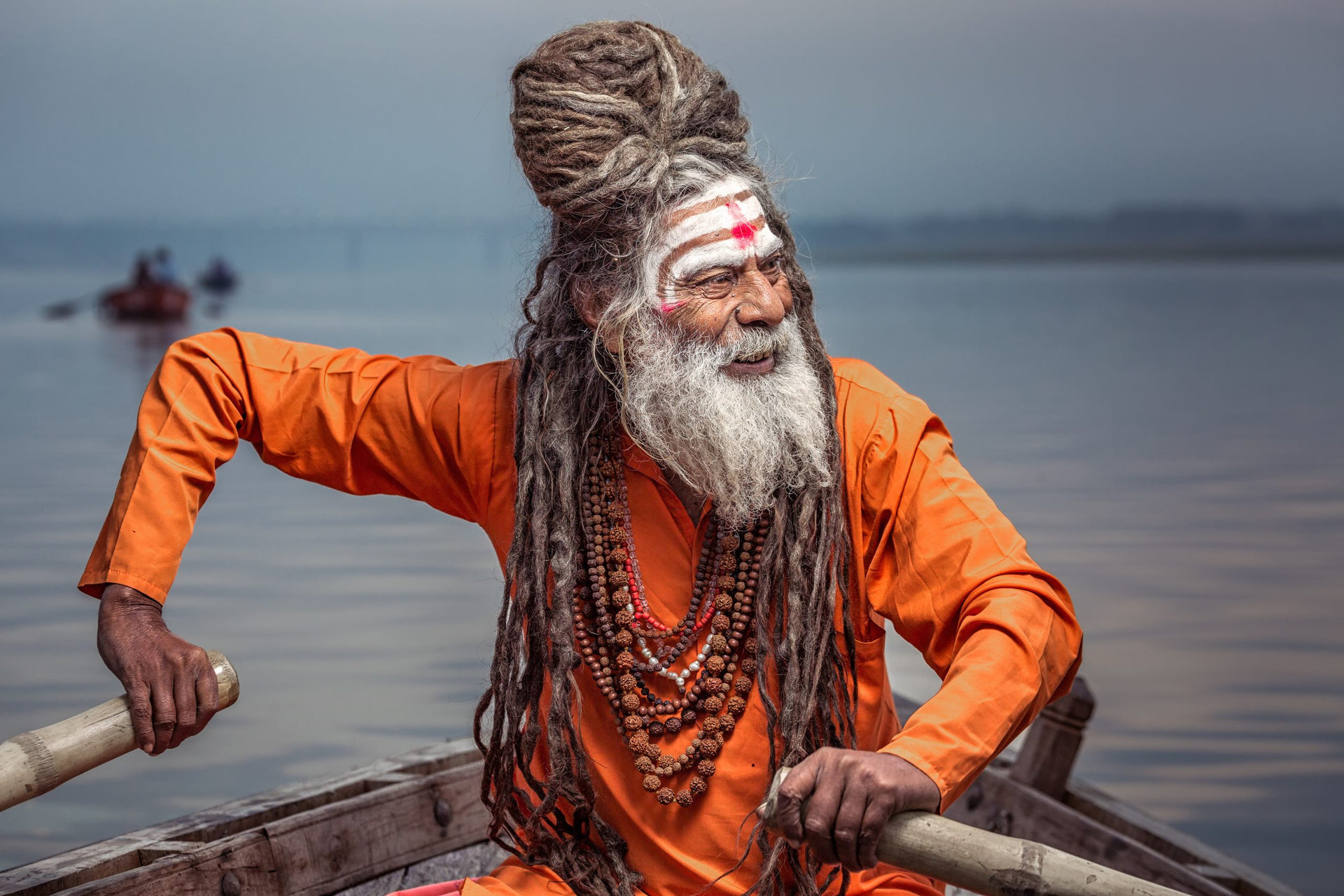 Portrait of sadhu rowing in the boat, Varanasi, India.